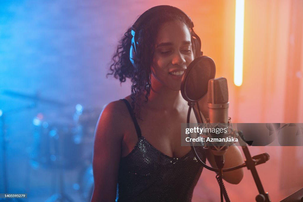 Hispanic Woman Recording A New Pop Single In The Recording Studio