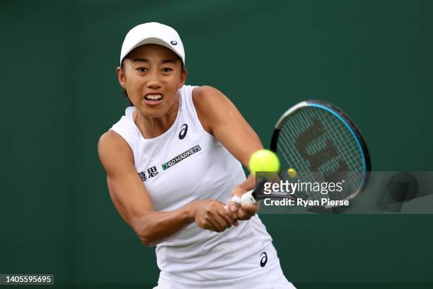 Shuai Zhang of China plays a backhand against Misaki Doi of Japan during their Women's Singles First Round Match on day two of The Championships...