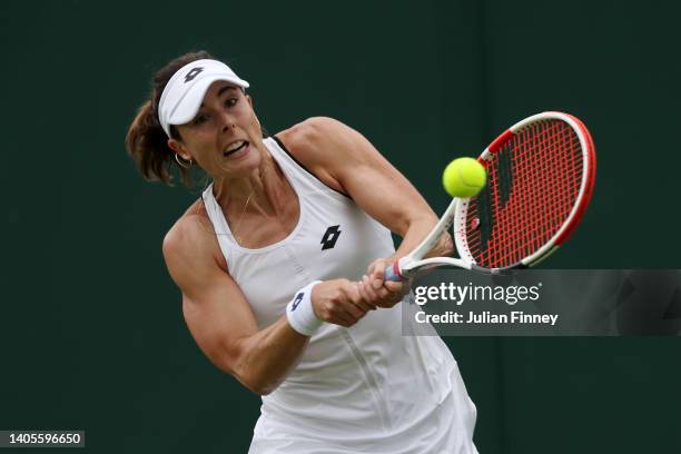 Alize Cornet of France plays a backhand against Yulia Putintseva of Kazakhstan during their Women's Singles First Round Match on day two of The...