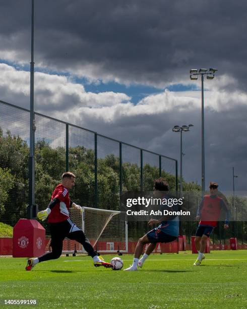 Tom Heaton and Zidane Iqbal of Manchester United in action during a first team training session at Carrington Training Ground on June 27, 2022 in...