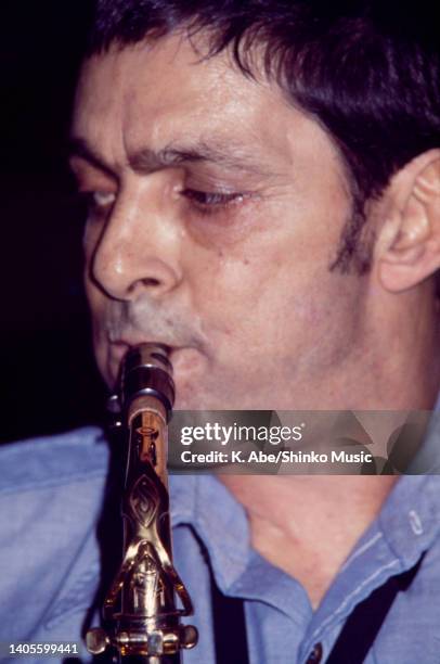 Art Pepper plays the alto saxophone in blue shirt, close up, unknown, circa 1970s.