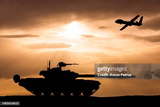 armored tank and combat drone on the background of the sunset sky - ejército fotografías e imágenes de stock