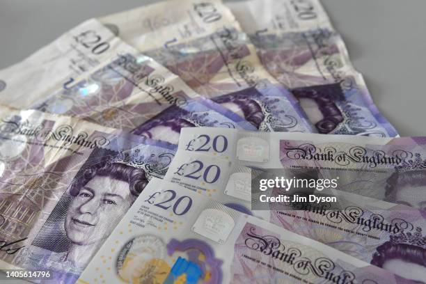 Photo illustration of British paper £20 banknotes, alongside the polymer replacement, that will soon be taken out of circulation, June 28, 2022 in...