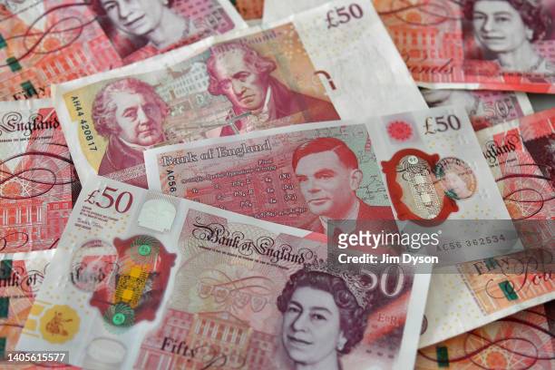 Photo illustration of the new British polymer £50 banknote featuring scientist Alan Turing, alongside the old paper £50 banknote, featuring engineers...