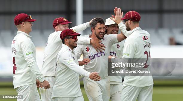 Simon Kerrigan of Northamptonshire celebrates with team mates after taking the wicket of Chris Benjamin during the LV= Insurance County Championship...
