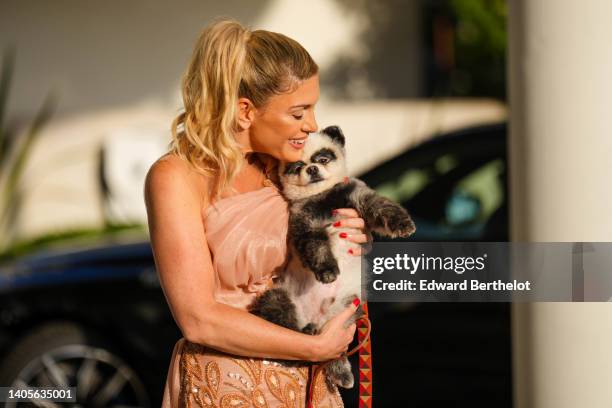 Hofit Golan wears a beige gold shiny tulle asymmetric knot shoulder / long tube embroidered sequined and pearls dress, during the 75th annual Cannes...