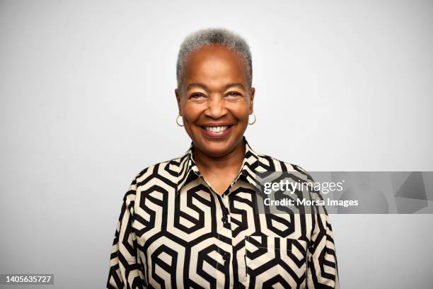 smiling senior woman against white background - old person on white background stockfoto's en -beelden