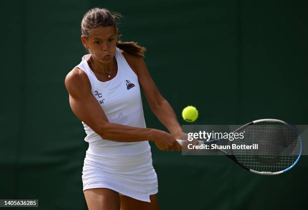 Chloe Paquet of France plays a backhand against Irina Bara of Romania during their Women's Singles First Round Match on day two of The Championships...