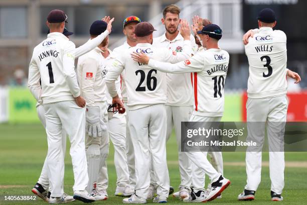 Tom Bailey of Lancashire celebrates with team mates after capturing the wicket of George Scott of Gloucestershire during day three of the LV=...