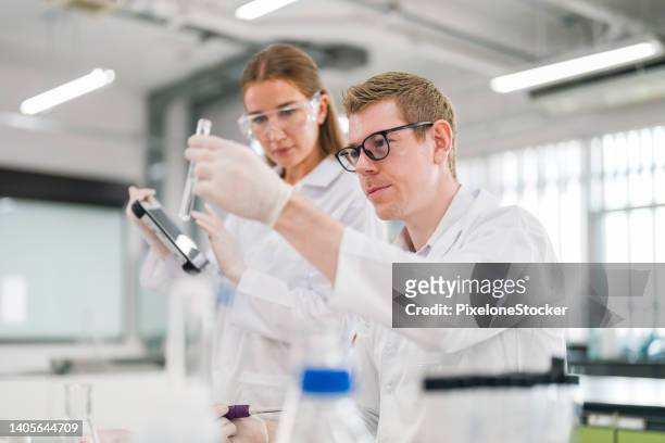 scientists working in laboratory for analyzing chemical in test tube. - microbiology stock-fotos und bilder