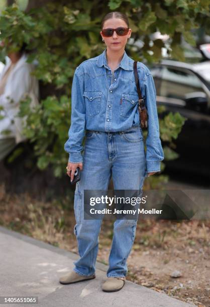 Guest seen wearing brown sunglasses, a blue button denim shirt, a blue denim jeans pants, a brown leather shoulder bag and beige suede sandals from...