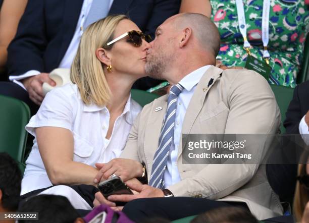 Zara Phillips and Mike Tindall kiss as they attend Day Two of Wimbledon 2022 at All England Lawn Tennis and Croquet Club on June 28, 2022 in London,...