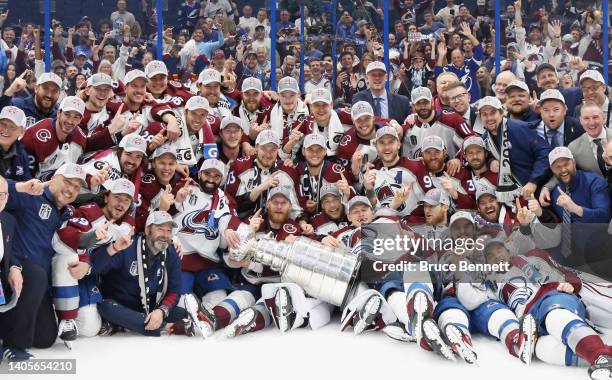 The Colorado Avalanche pose with the Stanley Cup following the series winning victory over the Tampa Bay Lightning in Game Six of the 2022 NHL...