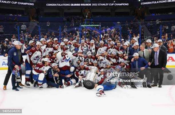 Nicolas Aube-Kubel of the Colorado Avalanche trips and drops the Stanley Cup following the series winning victory over the Tampa Bay Lightning in...