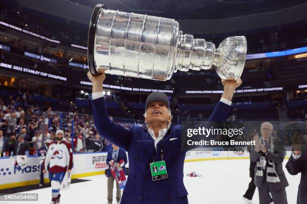 Stanley Kroenke of the Colorado Avalanche carries the Stanley Cup following the series winning victory over the Tampa Bay Lightning in Game Six of...