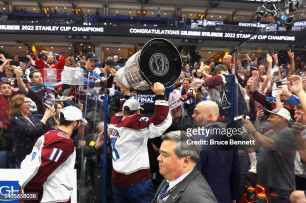 Jack Johnson of he Colorado Avalanche carries the Stanley Cup following the series winning victory over the Tampa Bay Lightning in Game Six of the...