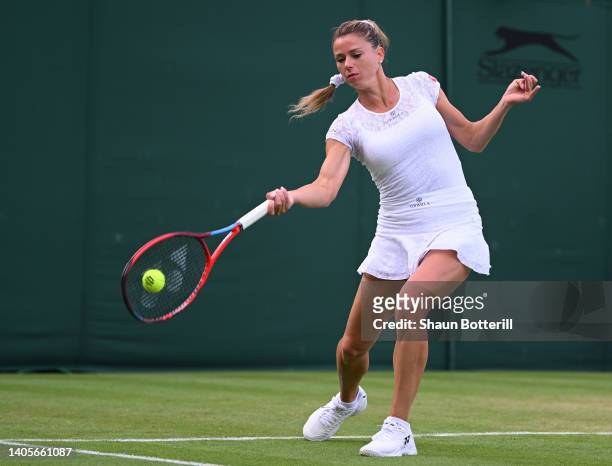Camila Giorgi of Italy plays a forehand against Magdalena Frech of Poland during their Women's Singles First Round Match on day two of The...