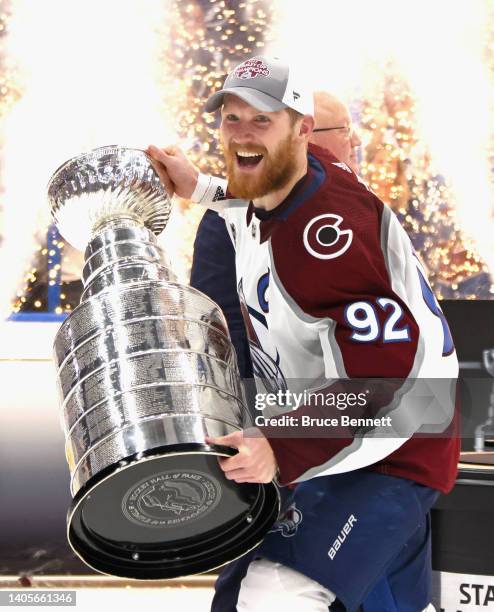 Gabriel Landeskog of the Colorado Avalanche carries the Stanley Cup following the series winning victory over the Tampa Bay Lightning in Game Six of...