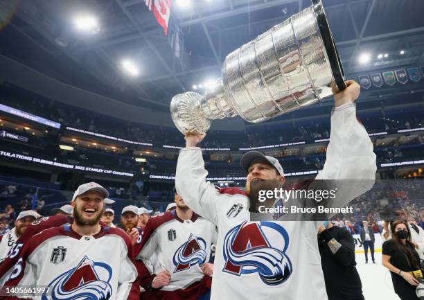 Nathan MacKinnon of the Colorado Avalanche carries the Stanley Cup following the series winning victory over the Tampa Bay Lightning in Game Six of...