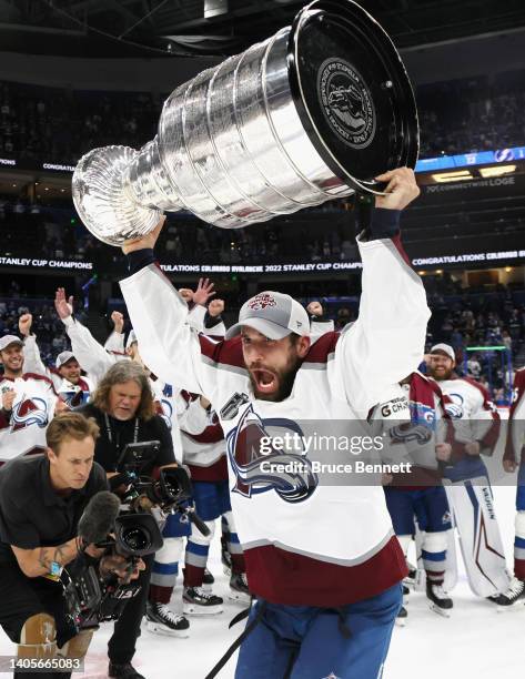 Andrew Cogliano of the Colorado Avalanche carries the Stanley Cup following the series winning victory over the Tampa Bay Lightning in Game Six of...