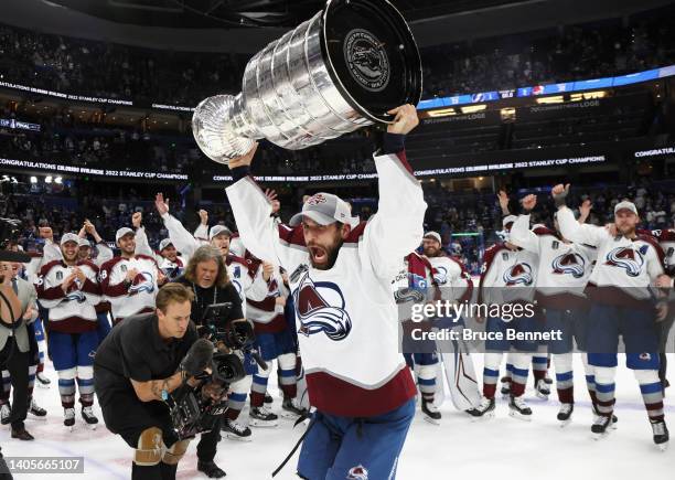 Andrew Cogliano of the Colorado Avalanche carries the Stanley Cup following the series winning victory over the Tampa Bay Lightning in Game Six of...