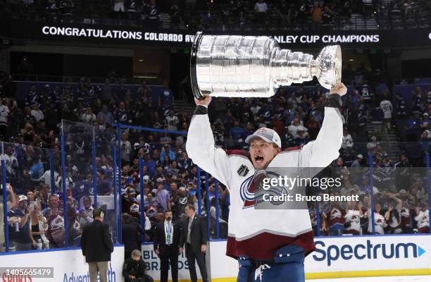 Erik Johnson of the Colorado Avalanche carries the Stanley Cup following the series winning victory over the Tampa Bay Lightning in Game Six of the...