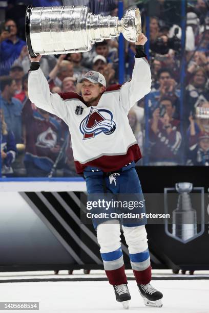 Erik Johnson of the Colorado Avalanche lifts the Stanley Cup in celebration after Game Six of the 2022 NHL Stanley Cup Final at Amalie Arena on June...