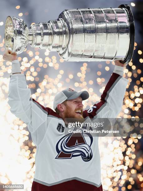 Gabriel Landeskog of the Colorado Avalanche lifts the Stanley Cup in celebration after Game Six of the 2022 NHL Stanley Cup Final at Amalie Arena on...