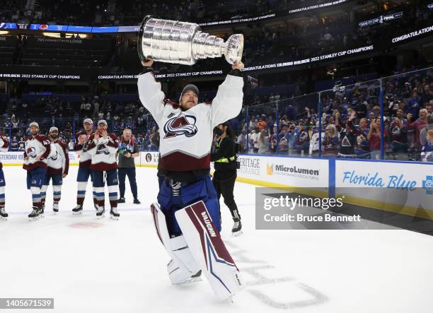 Darcy Kuemper of the Colorado Avalanche carries the Stanley Cup following the series winning victory over the Tampa Bay Lightning in Game Six of the...