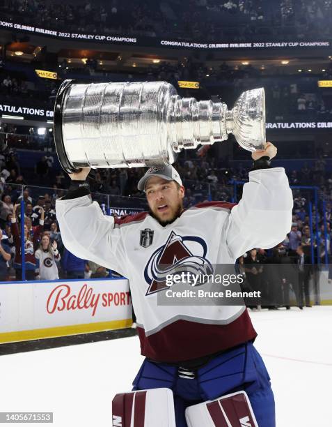 Darcy Kuemper of the Colorado Avalanche carries the Stanley Cup following the series winning victory over the Tampa Bay Lightning in Game Six of the...