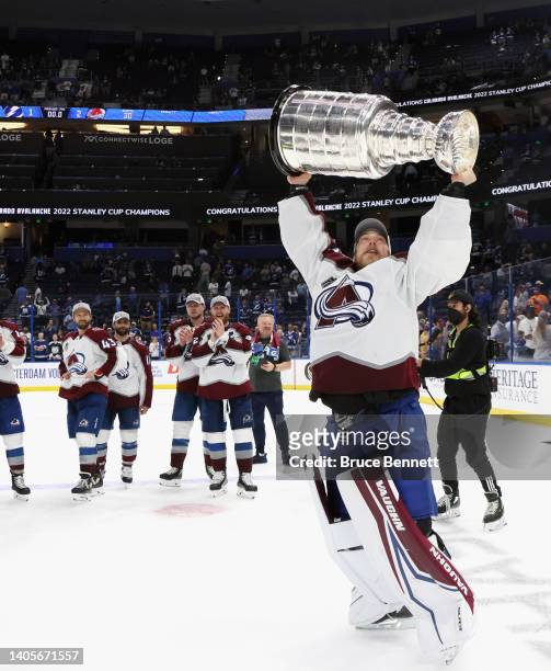 Darcy Kuemper of the Colorado Avalanche carries the Stanley Cup following the series winning victory over the Tampa Bay Lightning in Game Six of the...