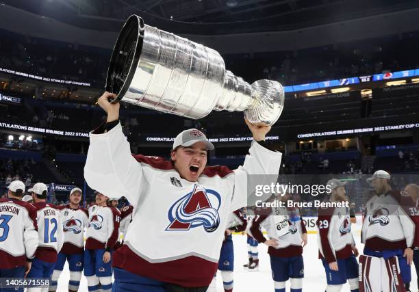 Darcy Kuemper of the Colorado Avalanche carries the Stanley Cup following the series winning victory over the Tampa Bay Lightning in Game Six of the...