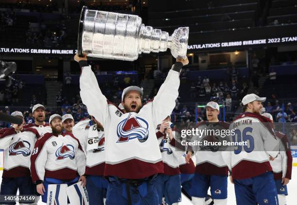 Darren Helm of the Colorado Avalanche carries the Stanley Cup following the series winning victory over the Tampa Bay Lightning in Game Six of the...