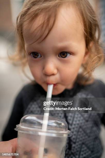 an adorable girl quenching her thirst - straw lips stock pictures, royalty-free photos & images