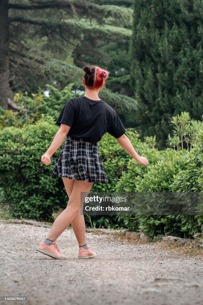 Full length body size photo of dreamy cheerful happy modern girl dancing in dress in park