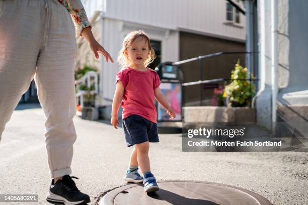 baby girl bravely exploring kragerø - kragerø stock pictures, royalty-free photos & images