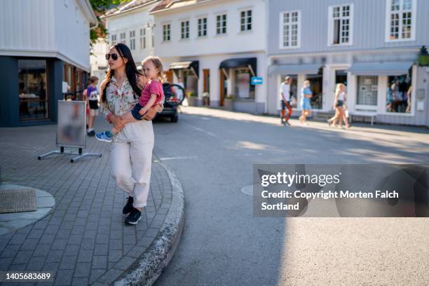 mom and daughter enjoying an afternoon stroll - kragerø stock pictures, royalty-free photos & images