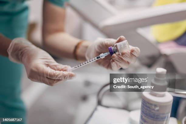female doctor filling syringe - beauty treatment stock pictures, royalty-free photos & images
