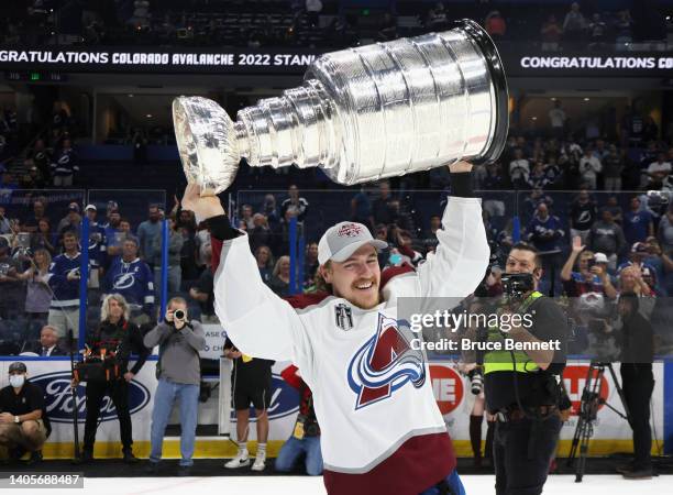 Nicolas Aube-Kubel of the Colorado Avalanche carries the Stanley Cup following the series winning victory over the Tampa Bay Lightning in Game Six of...