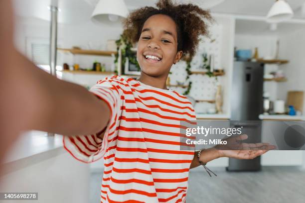 teenage girl posing to mobile phone camera at home - very young webcam girls stockfoto's en -beelden