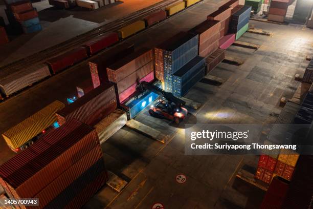 aerial top view forklift working at night in container cargo warehouse for business logistics, import export, shipping or freight transportation. - ships bridge 個照片及圖片檔
