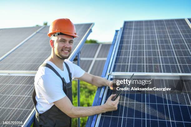 smiling male worker happy with his job repairing solar panels - live in levis event stock pictures, royalty-free photos & images