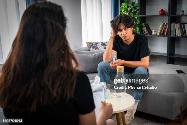 teenager aus dem nahen osten mit psychotherapiesitzung im büro des psychologen - bipolar stock-fotos und bilder