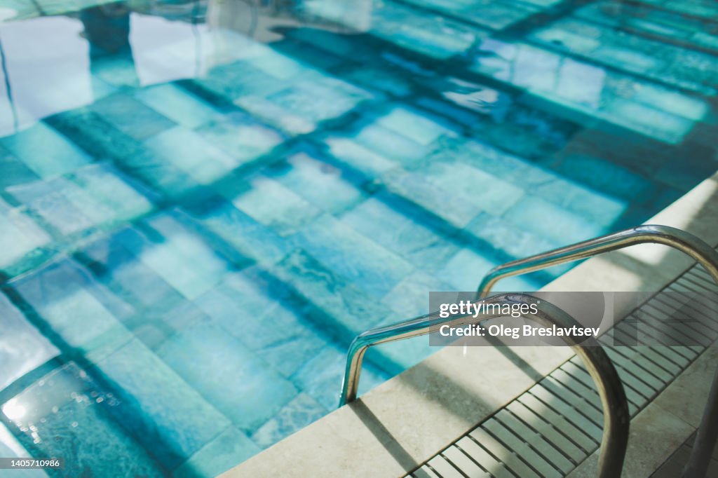 Background of swimming pool with handrails. No people and room for copy space