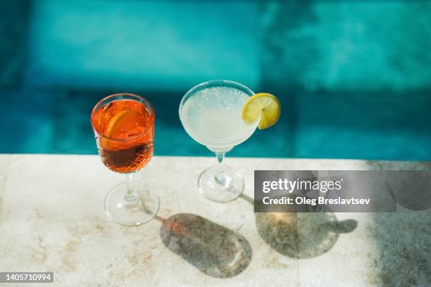 two cold fresh summer cocktails on poolside close-up. spritz and margarita - poolside cocktail party bildbanksfoton och bilder