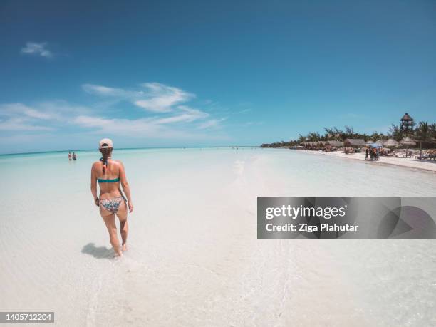 woman in biking on paradise beach - isla holbox stock pictures, royalty-free photos & images