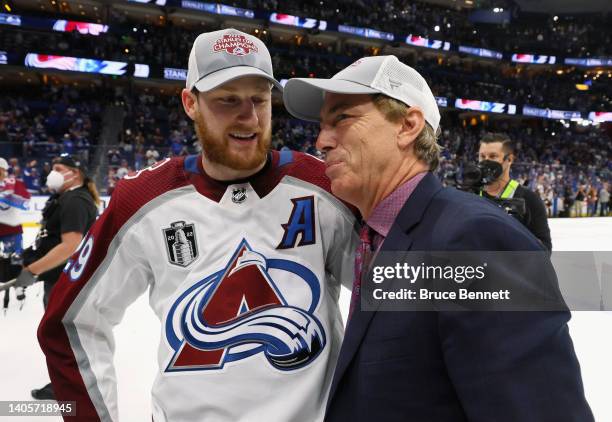 Nathan MacKinnon of the Colorado Avalanche and Joe Sakic chat following the series winning victory over the Tampa Bay Lightning in Game Six of the...