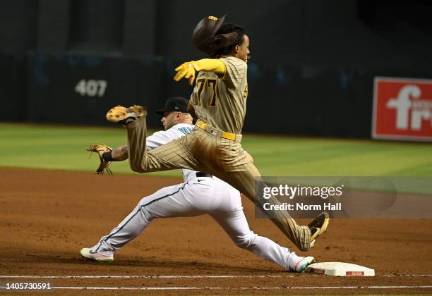 Abrams of the San Diego Padres beats out a bunt ahead of the throw to Christian Walker of the Arizona Diamondbacks in the fifth inning at Chase Field...