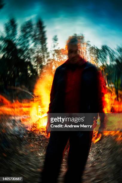 moving man fire at night in forest - andrew eldritch stock-fotos und bilder