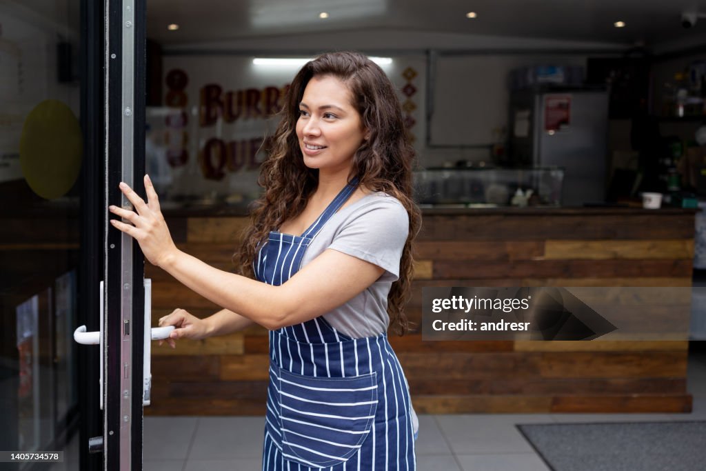 Business owner opening the doors of a Mexican restaurant